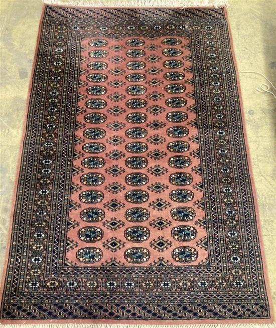 A Bokhara style pink ground rug, 194 x 131cm